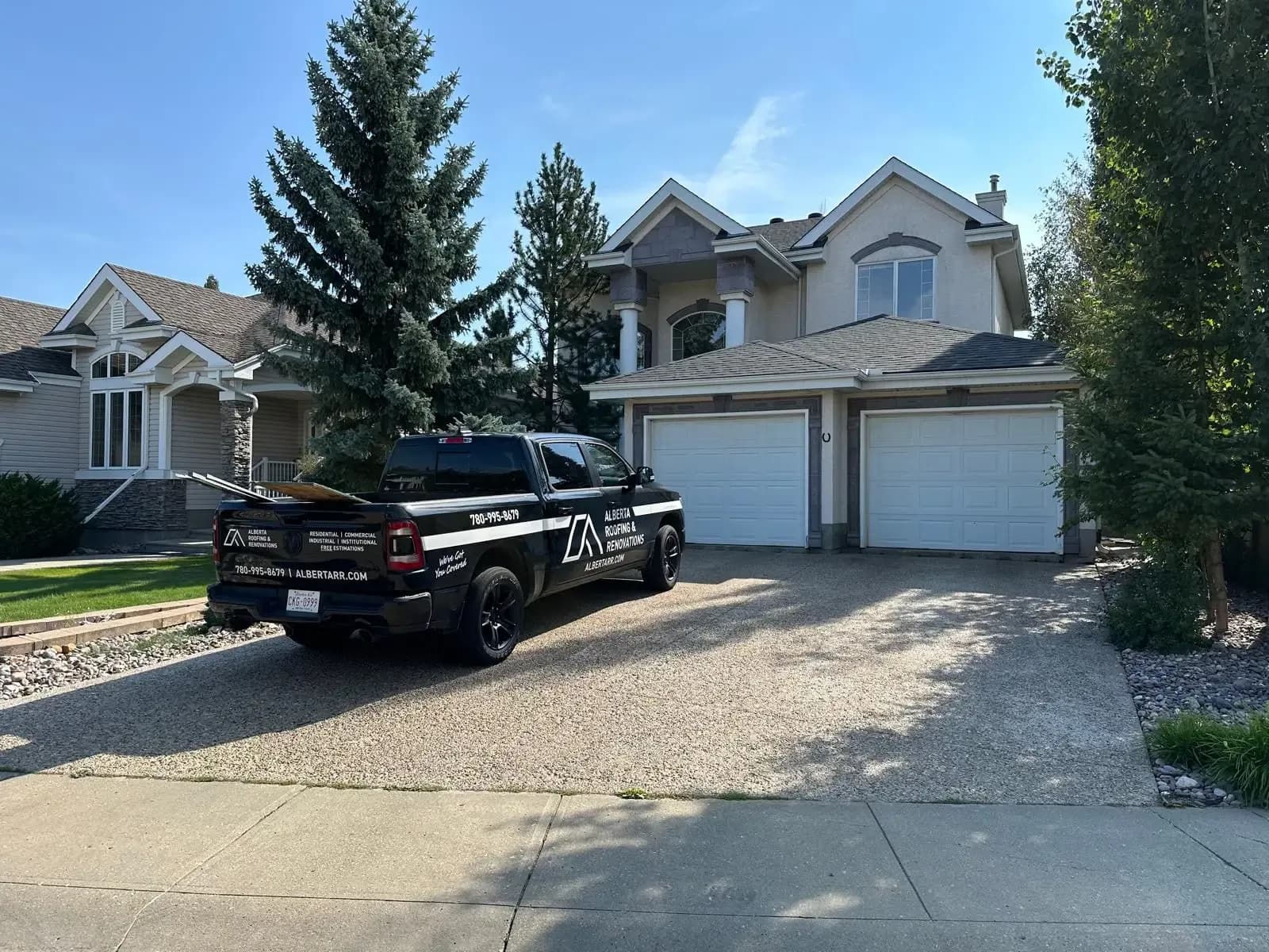 Company truck in the driveway of a home after a new roof