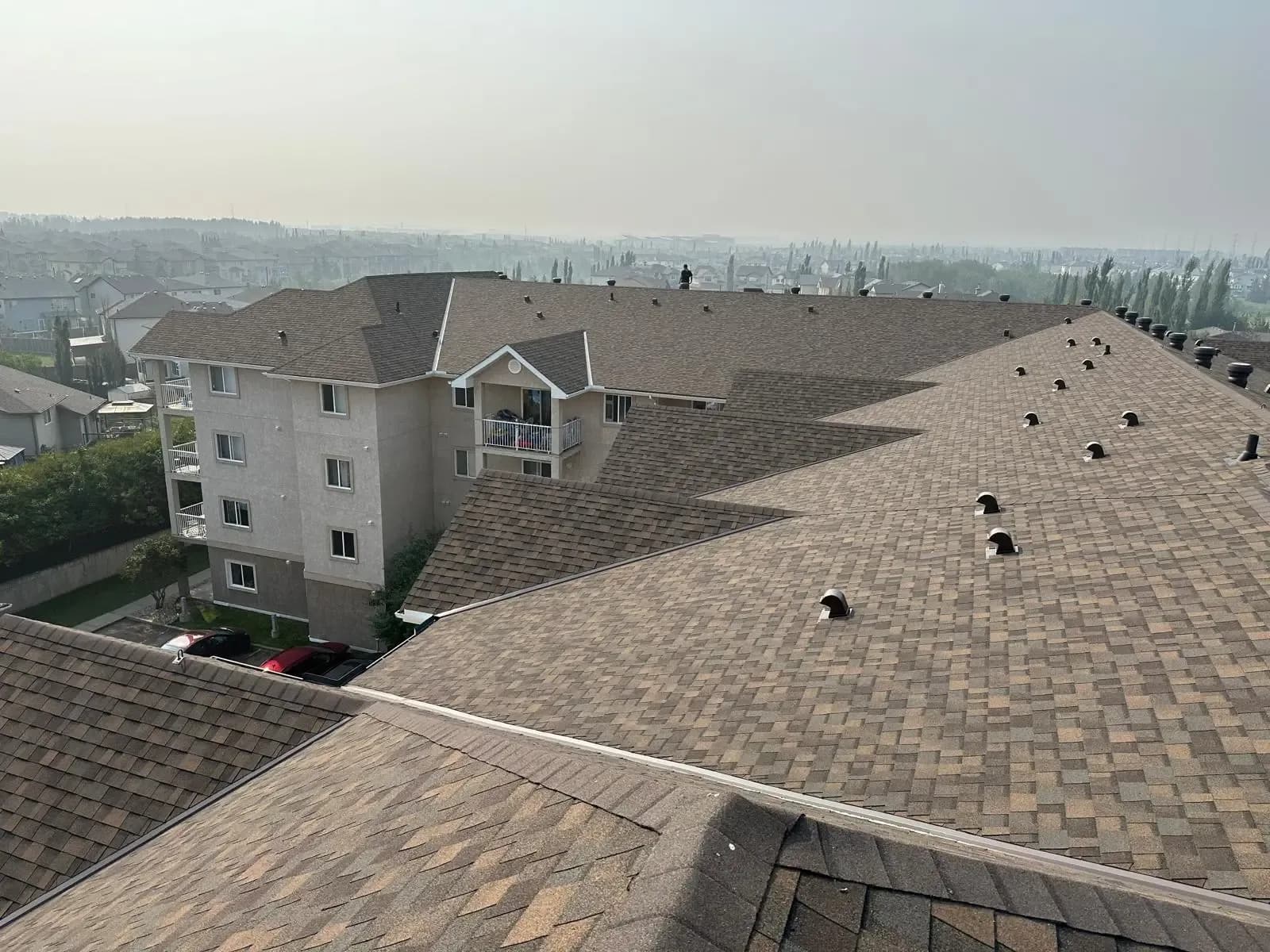 Brown shingle roof on a low-rise apartment building